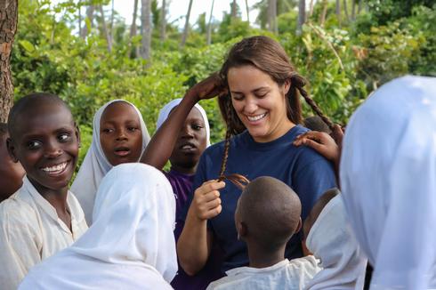 Students in Tanzania are required to keep their hair short, so they loved getting to braid Anna's.